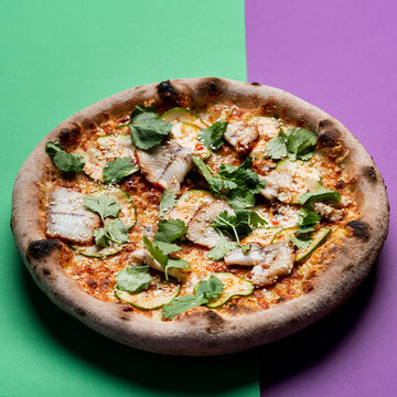 Seafood gourmet pizza with trout fillet and parsley, top view, studio shot with soft light