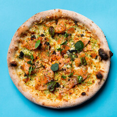 Keto salmon pizza with herbs and sprouts on colorful bright background