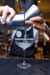 bartender pouring cocktail