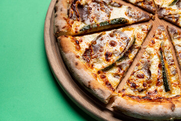 Close up of zucchini pizza slices on bright colorful background for a culinary magazine