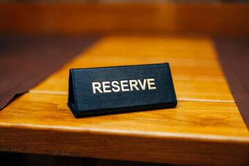 Sign reserve on a wooden table in a restaurant