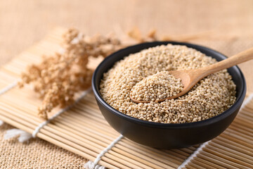 Brown quinoa seeds in a bowl with spoon, Edible seeds are high protein, Healthy food