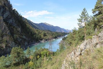 Goat trail on Chemal in the Altai Mountains with a view of the Katun mountain river in summer