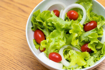 Salad green oak and tomato. Breakfast diet menu. Fresh salad in morning on the wood table.