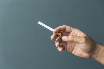 A young man with a cigarette He is going to smoke. It is dangerous to the people around. world tobacco day.