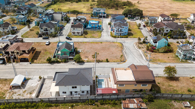 Aerial of a typical township or gated village in the Philippines. Many lots are still empty or undeveloped. In Bacoor, Cavite.