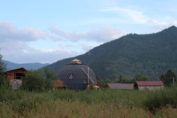 Rural rural landscape with a large hexagonal house for tourists in the Mountains