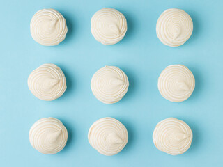 Top view of fresh vanilla meringue on a blue background.