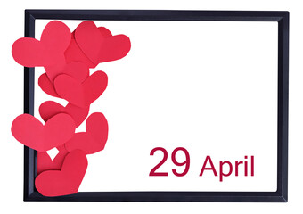 Day 29 of April month and red paper hearts. Empty space for text.