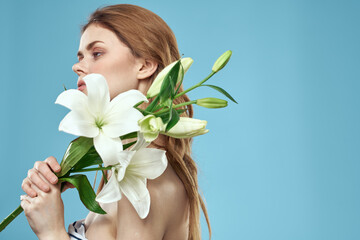 Obraz na płótnie Canvas Attractive Lady white flowers blue background portrait cropped view