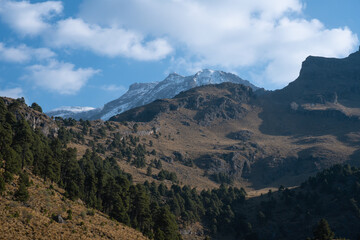 Stunning view of the snow-capped Iztaccihuatl volcanic mountain top in Mexico under a cloudy sky