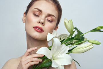 woman with white flowers on gray background portrait close-up makeup mode