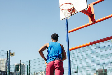 Basketball player running on basketball court