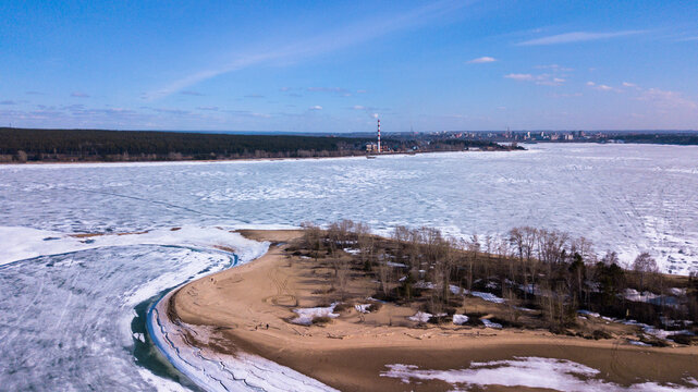 Aerial view of the frozen river bay and thermal power plant with the city of Berdsk in the background, photo by drone