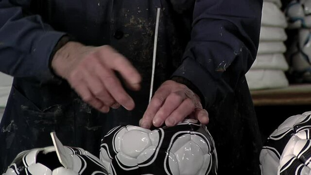 Worker at the Production Line in a  Soccer Ball Factory.  