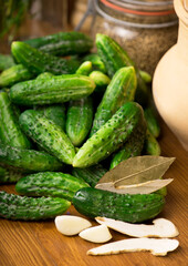 Food background. Organic products, healthy food, harvesting for future use, pickling vegetables, pickling cucumbers. Cucumbers with garlic, salt, dill and empty glass jar for pickling.