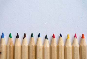 Kid Art education concept. Color pencils on white paper background. copy space