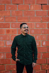 Obraz premium portrait of male model with green military t-shirt on brick wall