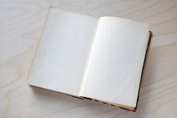 Old vintage book on wooden table. Open book with blank pages