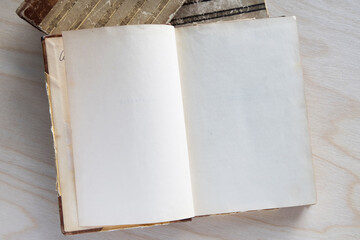 Old vintage book on wooden table. Open book with blank pages