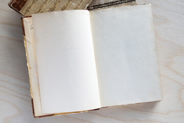 Old vintage book on wooden table. Open book with blank pages