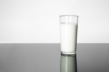 Milk and fermented milk products: benefits for the body. A glass of milk on the table.