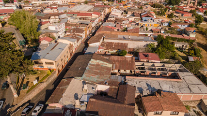 Old houses and streets of the magical town of "El Oro" State of Mexico, the characteristic roofs of these houses match the forest