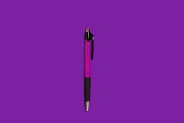 automatic pen lying on a purple background