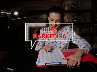  BUZZ MARKETING inscription on the screen. Businesswoman inspecting market data.