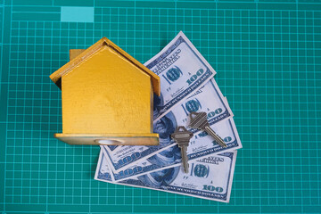Golden house with key on bank note ,business concept.