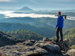 Fototapeta premium Photographer use mirror camera and tripod on peak