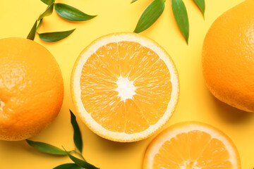 Fresh oranges with green leaves on color background