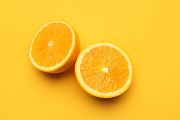 Pieces of fresh orange fruit on color background