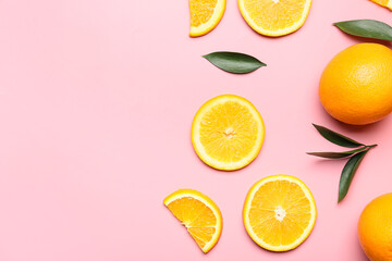 Fresh oranges with green leaves on color background