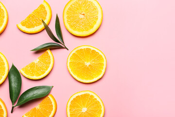 Slices of fresh oranges with green leaves on color background