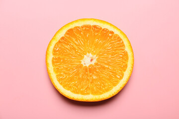 Piece of fresh orange fruit on color background