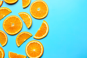 Slices of fresh oranges on color background