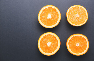 Pieces of fresh oranges on dark background