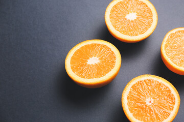 Pieces of fresh oranges on dark background