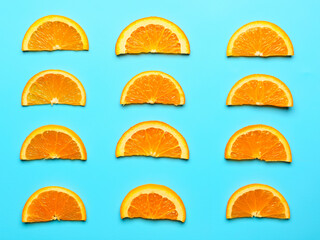 Slices of fresh oranges on color background