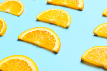 Slices of fresh oranges on color background