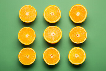 Pieces of fresh oranges on color background