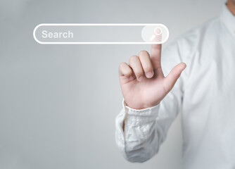 Man standing with hands pointing to information search is a data clicking to virtual internet search page computer touch screen. Education, Knowledge, Analysis the Internet to connect wirelessly. - obrazy, fototapety, plakaty