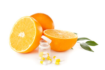 Bottle with vitamin C pills and oranges on white background