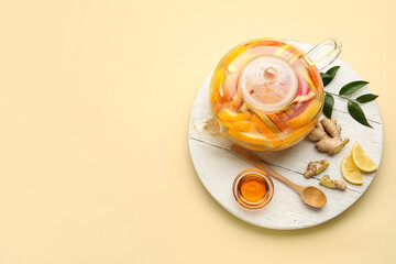 Composition with teapot of tasty ginger tea and ingredients on color background