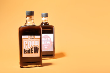 Bottles of cold brew on color background