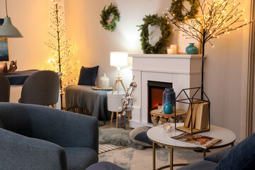 Interior of modern room with fireplace decorated for Christmas