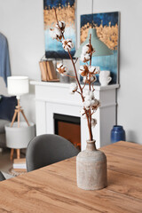 Vase with cotton flowers in interior of modern dining room