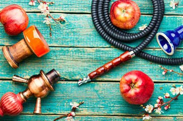 Smoking hookah or shisha with apple flavor
