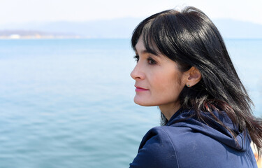 Portrait of 45 y.o. Russian woman against the Japanese sea 